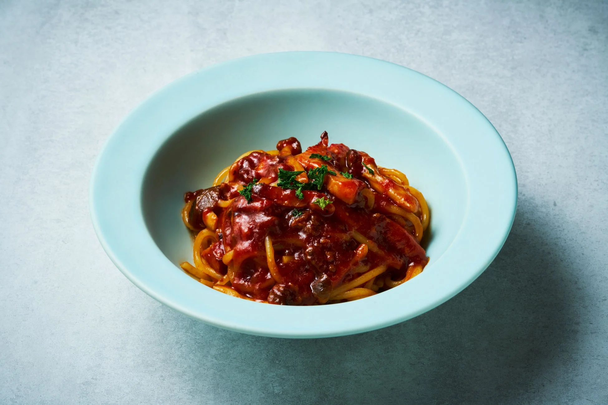 濃厚な赤色のソースがかかったパスタ