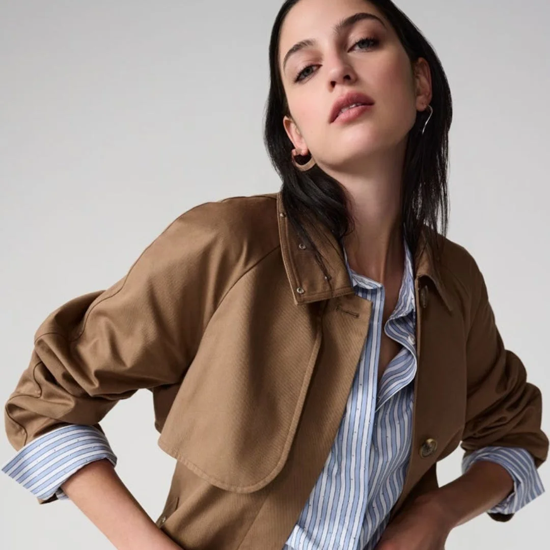 ブラウンのジャケットとストライプシャツを着用した女性