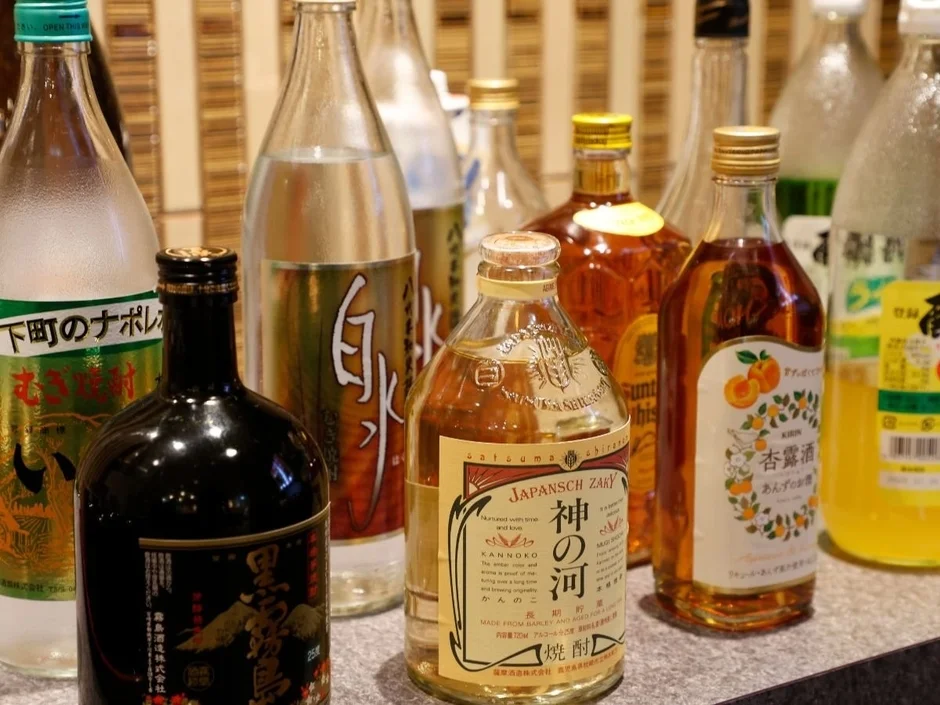 様々な日本のお酒ボトルが並ぶ