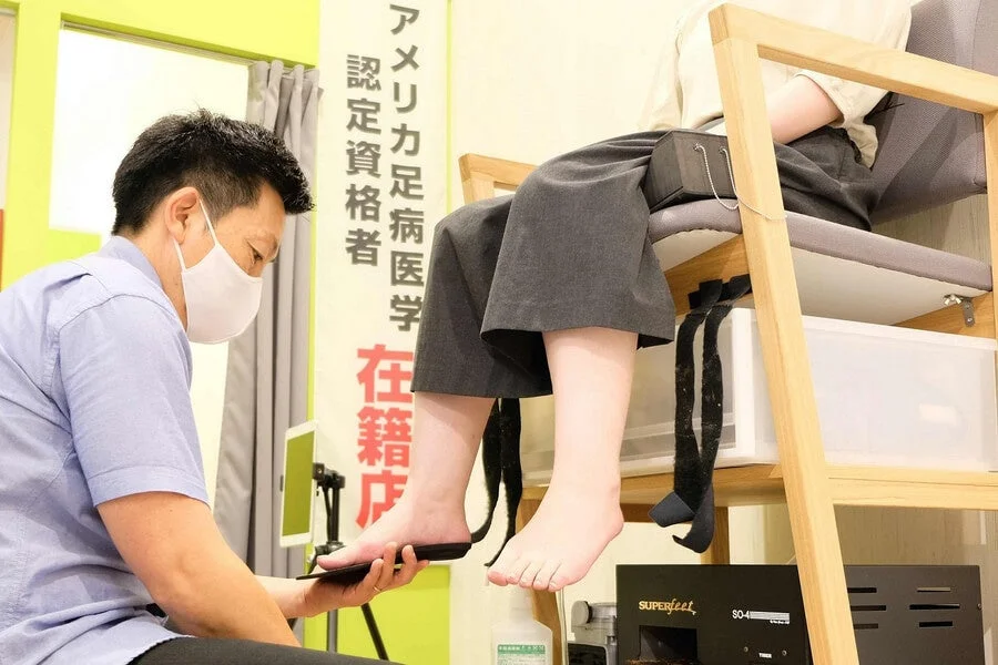 足の測定をする専門家