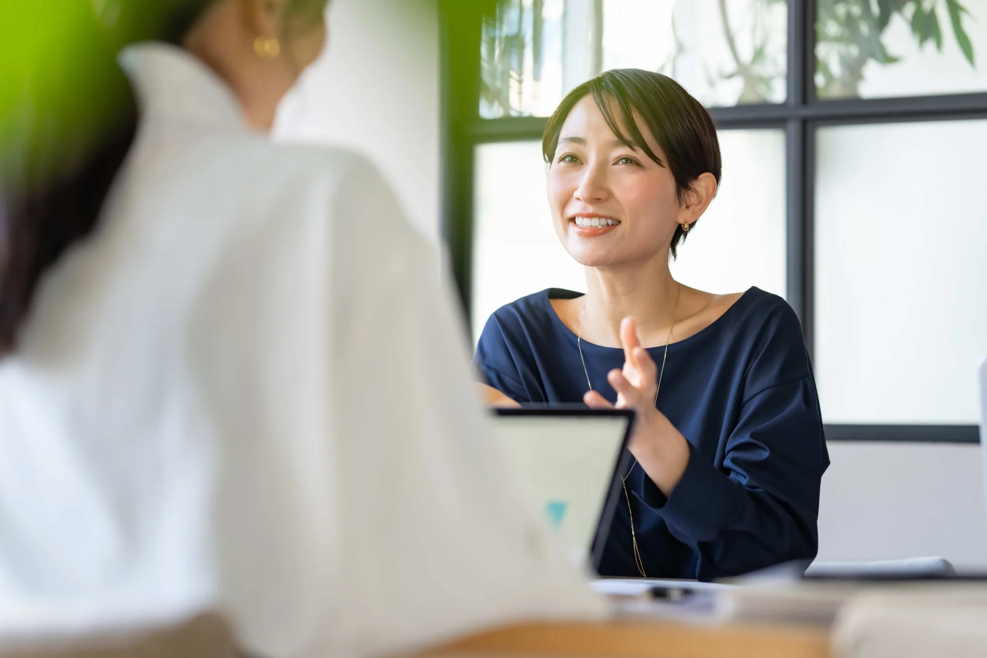 オフィスで二人の女性が会話している様子