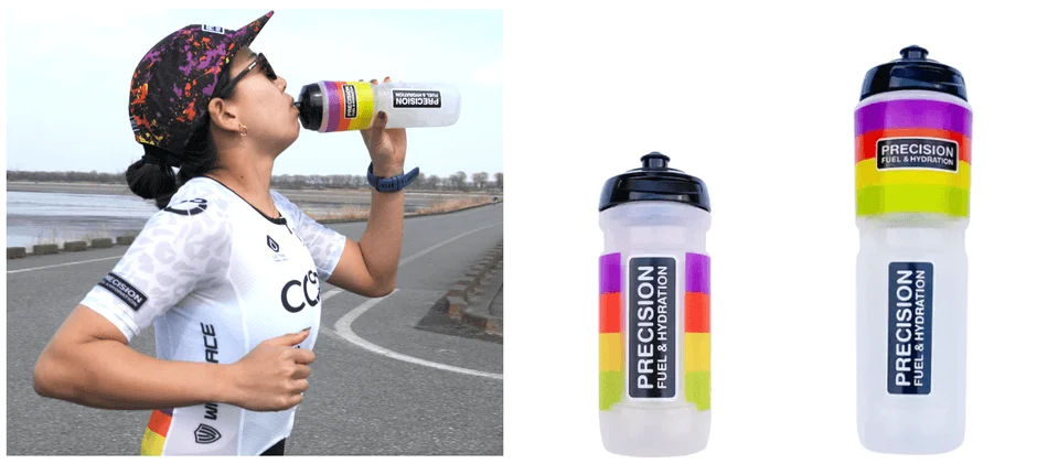 スポーツウェアを着た人物が屋外で「PRECISION FUEL & HYDRATION」のボトルから水分補給をしている様子