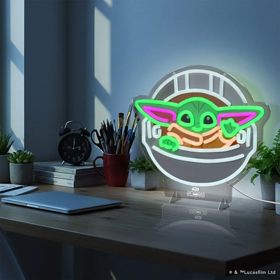 ノートPCと植物のあるデスクのネオンサイン