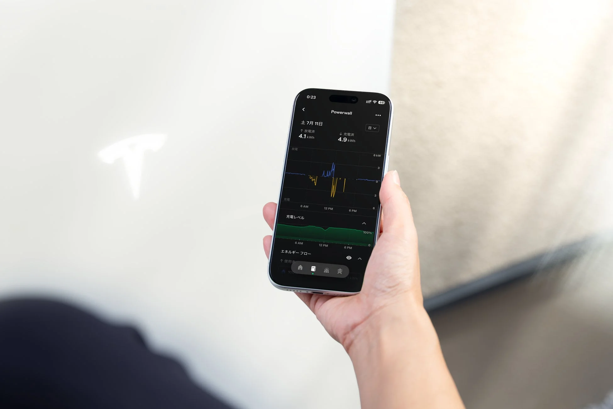 スマートフォンでテスラPowerwallのエネルギー管理アプリを操作している様子