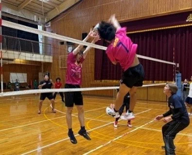 体育館でバレーボールをする選手