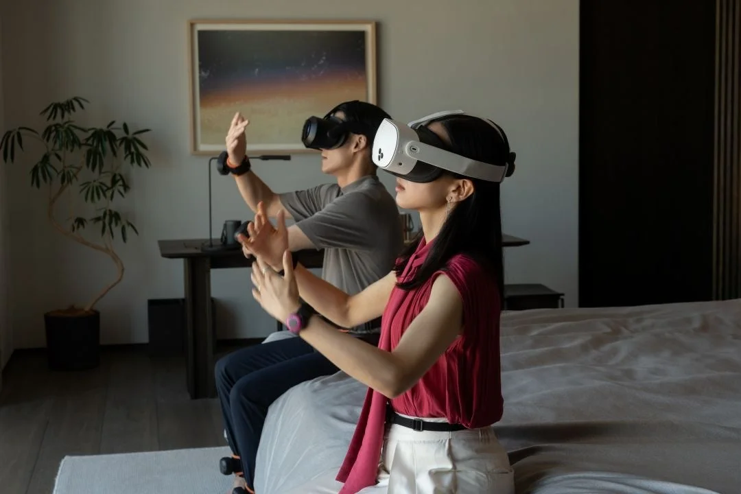 VRヘッドセットを装着して仮想空間を操作する男女