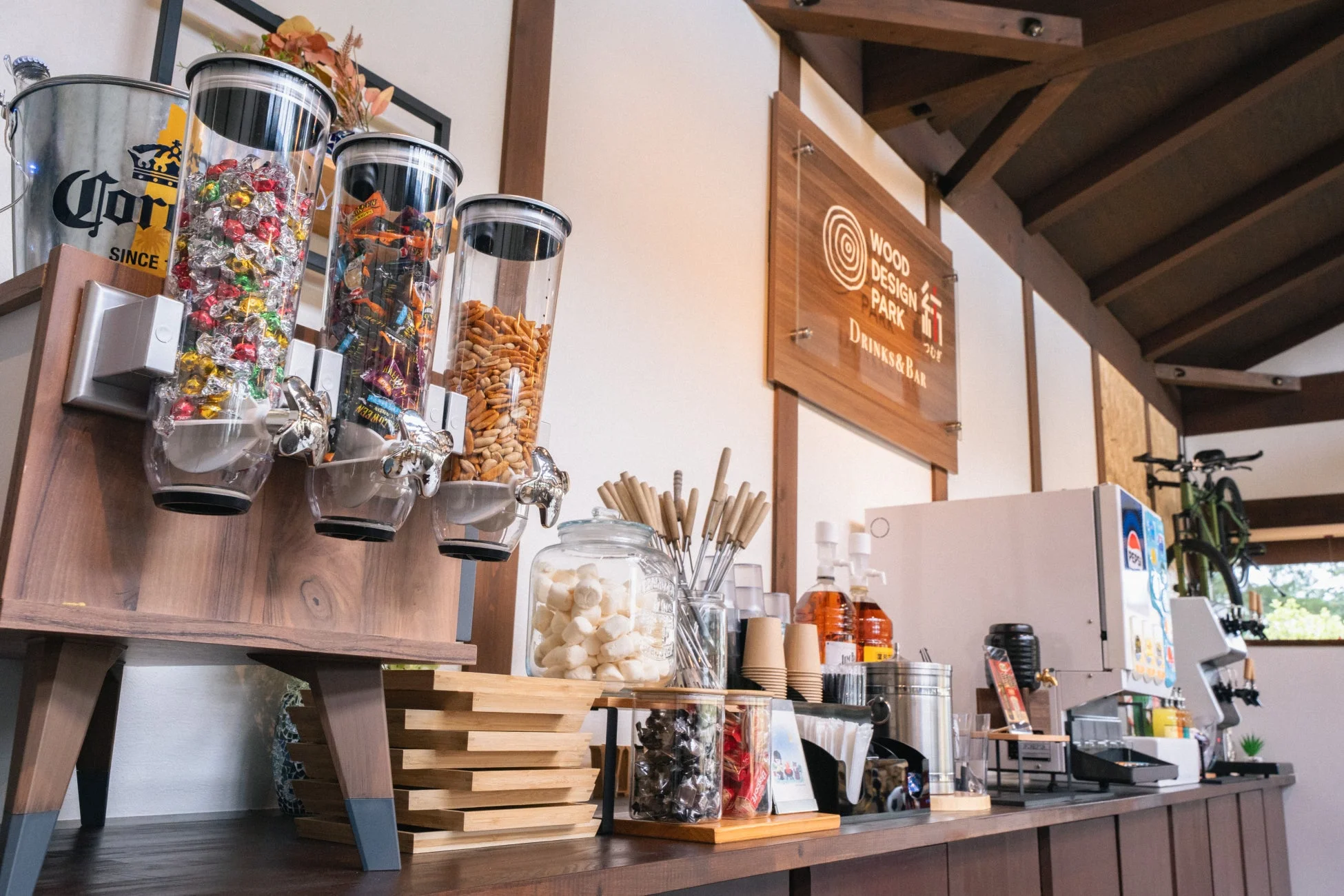 木造の建物内にあるセルフサービスのドリンクバーとスナックコーナー
